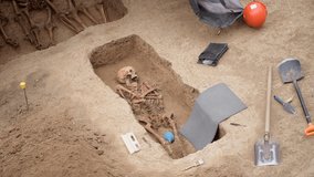 Archaeological site with skeleton in grave in good condition from archaeological excavations of world war in Europe. 4K High quality slow motion raw footage