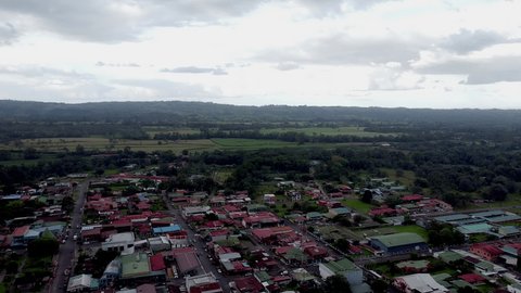 Aerial top view of a town in Costa Rica. Looking Down at colorful Roofed Buildings. High quality 4k footage. Wide Shot by Drone. Bird Flight view.