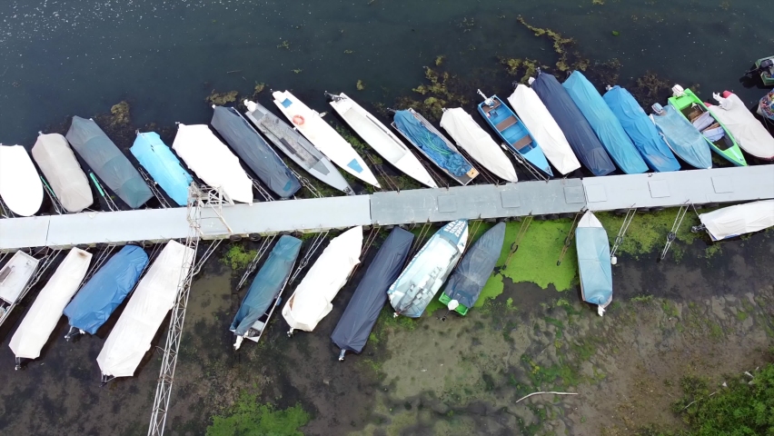 Italy - drought and aridity in Po river with no water and boats stopped in the harbor  - climate change and global warming, Drone view in Ponte bella Becca Pavia Lombardy and Ticino