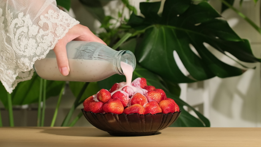 Strawberry. Yogurt pours on organic fresh red strawberries. Berries in whipped cream. Pouring yoghurt on strawberries slow motion. Organic, vegan food concept. Vitamin healthy dessert | Shutterstock HD Video #1091861017