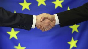 Businessmen shaking hands in the background of the flag of the European Union - Powered by Shutterstock - Get 15% off with code: PIKWIZARD15