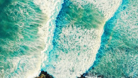 Aerial view - Beautiful  big blue ocean waves. Top view to the sea waves. Beautiful Ericeira famous tourist destination at Atlantic Ocean, Portugal. Drone view of rolling waves with white foam.