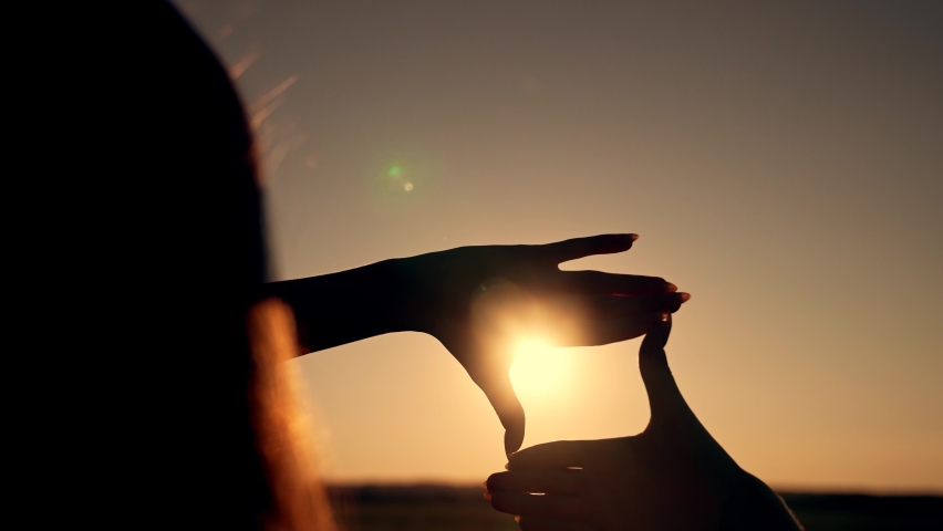 Business strategy. Girl folded her hands in frame at sunset. Silhouette of girl in natural park. Fingers at sunset. Work planning. Girl in field folded her hands into frame. Business planning concept. Royalty-Free Stock Footage #1091865381