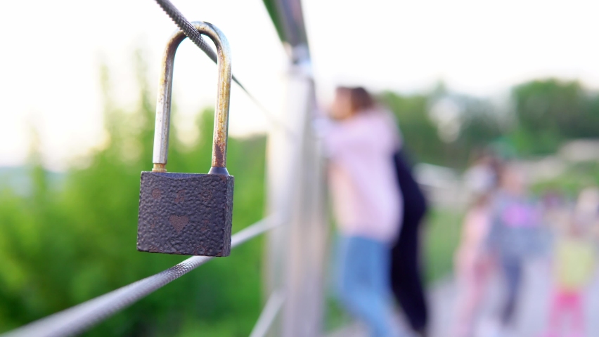 A wedding lock hangs on the railing. A wedding tradition all over the world to hinder the lock. Monument on the wedding day 4K