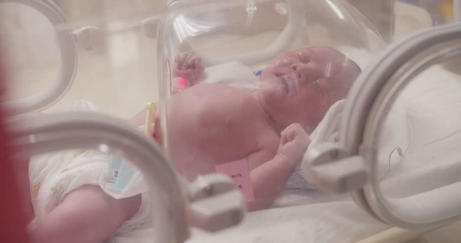 Closeup little newborn baby infant in incubators for newborns, Newborn baby having the the breathing problem after birth, newborn in NICU, Neonatal intensive care unit, healthcare Royalty-Free Stock Footage #1091871657
