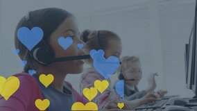 Animation of hearts over diverse children using phone headsets in office. Global business and digital interface concept digitally generated video.