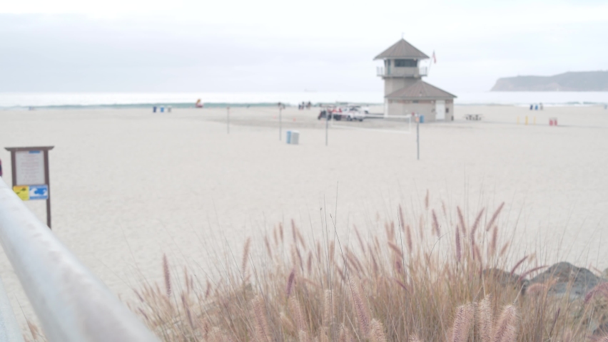 Lifeguard stand or life guard tower hut, surfing safety on California beach, USA. Rescue station, coast lifesavers wachtower or house, Coronado ocean beach, San Diego. Beach access stairs or steps.