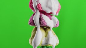 Colorful cookies in liquid cream. Stock clip. White cream flows down colorful cookies. Creative video with sweets and chromakey