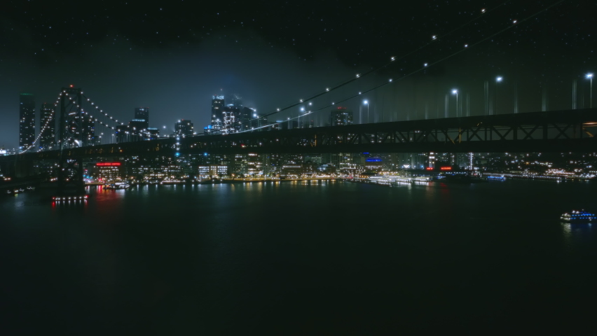 Scenic aerial view of night car traffic on illuminated suspension Bay bridge with San Francisco in foggy cloud on background. 4K urban cityscape, advanced innovation, financial technology energy power Royalty-Free Stock Footage #1091881567