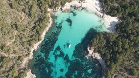 4k aerial video of the impressive landscape of turquoise waters Cala Des Talaier, in Menorca, Balearic Islands. A paradise of turquoise blue waters with incredible beaches and cove, Mitjana, Macarella
