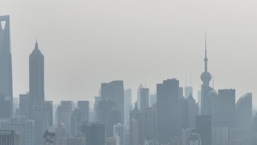 Drone aerial view of City skyline in the heavy fog in cloudy day. Long distance shot of skyline in Lujiazui downtown district in Shanghai China. Business, travel and economy concept b-roll footage.