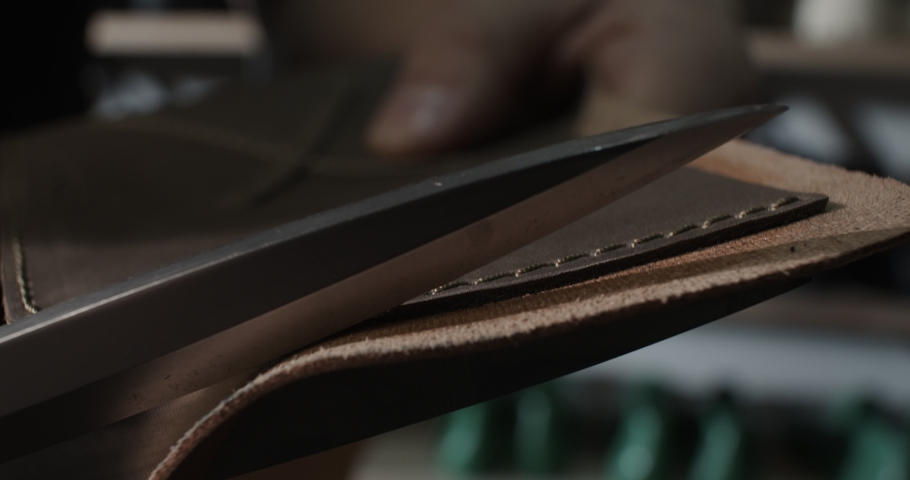 Close up view of tailor cut leather with scissors preparing blanks for making shoes, slow motion 4k | Shutterstock HD Video #1091895671