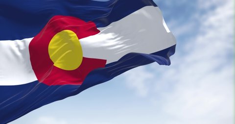 the flag of the US state of Colorado waving in the wind. Colorado is a state in the Mountain West subregion of the Western United States. Seamless loop in slow motion