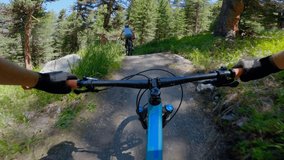 Mountain bikers ride along mountain trail in the morning. POV perspective view, biking along mountain slope.  - Powered by Shutterstock - Get 15% off with code: PIKWIZARD15