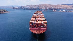 Aerial drone video flight over huge container cargo ship bow cruising the Mediterranean deep blue sea