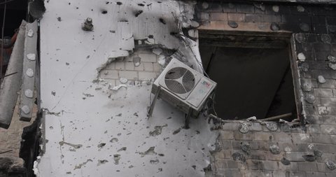 Borodyanka, Kyiv Oblast, Ukraine - summer 2022. The consequences of the bombing of Ukrainian cities. Destroyed burnt building. Air conditioner on the wall.