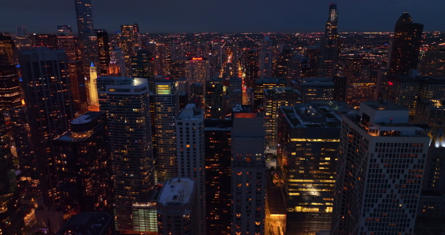 Wonderful skyline picture of impressive Chicago at night time. Light streets among beautiful skyscrapers from aerial perspective.