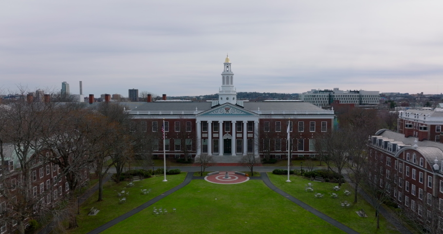 Dolly shot of Bloomberg Centre historic red brick building with columns and decorative entrance. Harvard University library. Boston, USA