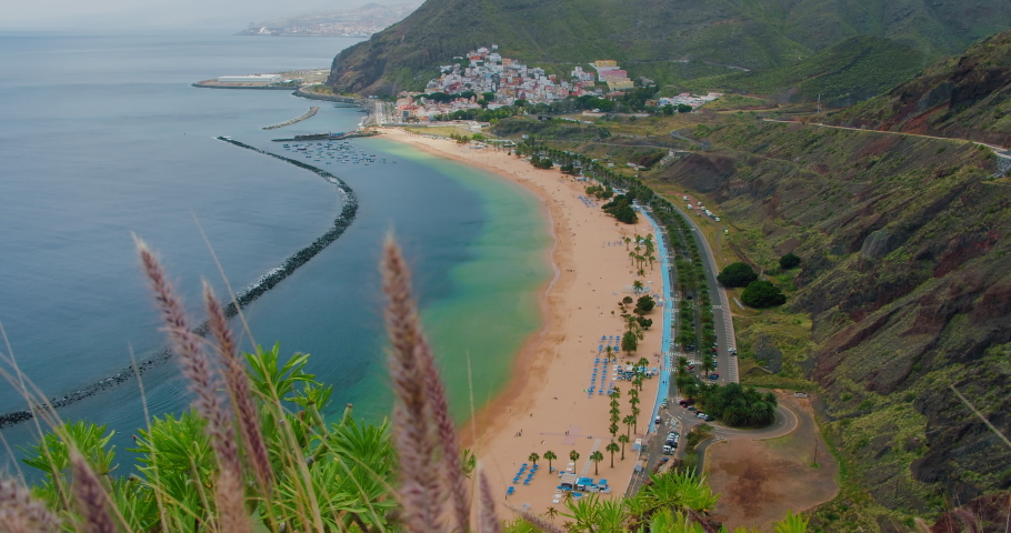 Best beach Las Teresitas in the world. View of the coastline in Tenerife. Ocean waves crashing on the white sand beach. Unrecognizable tourist relax on the shore. | Shutterstock HD Video #1091919039