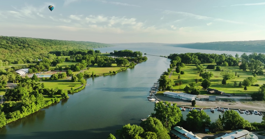 Ithaca NY USA June 26, 2022: Beautiful Hot Air Balloon near traveling over the  Cayuga Inlet and Cayuga Lake on a sunny Sunday morning