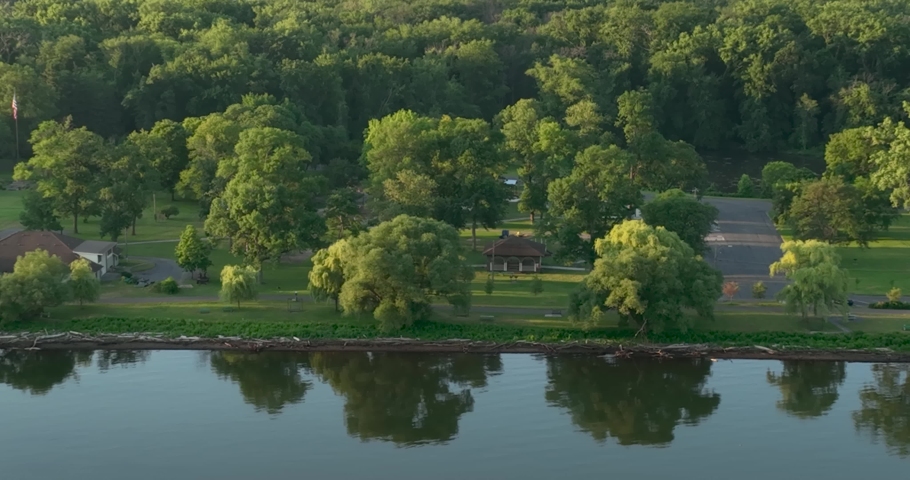 Ithaca NY USA June 26, 2022:  Early morning drone aerial flight over the south end of Cayuga Lake, near Ithaca New York, with a pull away view south of Stewart Park and the City of Ithaca.