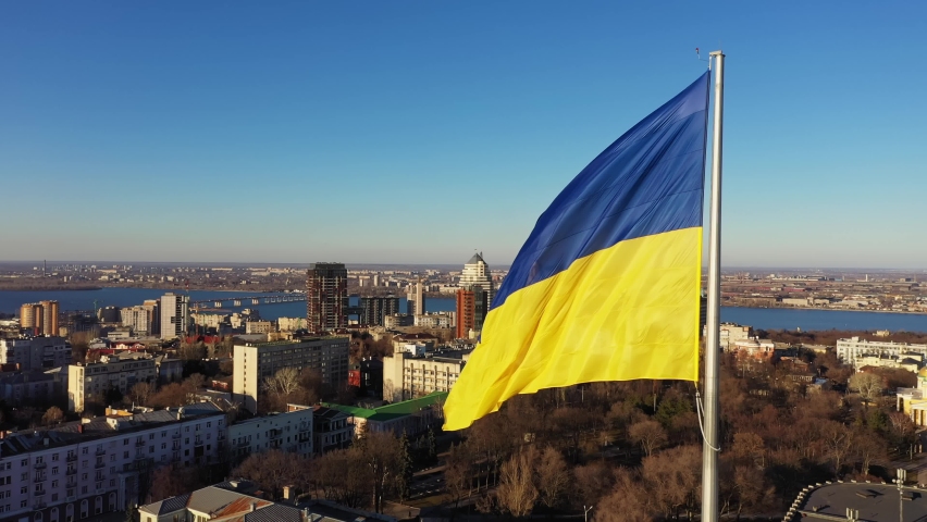 Yellow-blue flag of Ukraine wind waving. Ukraine National symbol. Dnipro city aerial view. | Shutterstock HD Video #1091920555