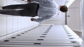 Technician walking in server hallway in high quality 4k format - Powered by Shutterstock - Get 15% off with code: PIKWIZARD15