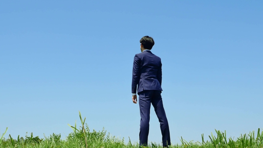 Asian businessman guts pose gesture under the clear sky | Shutterstock HD Video #1091924781