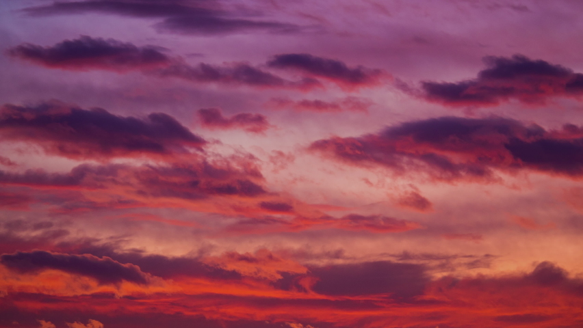 Red purple sunset sky clouds time lapse motion 4K footage background. Sunset sun light sky pass dark cloud fast move fly rolling weather time lapse background. Cloudscape 4K nature landscape day night | Shutterstock HD Video #1091925067