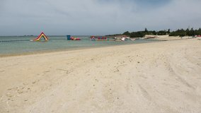 YOMITANSON, OKINAWA, JAPAN - AUGUST 2021 : View of Zanpa beach (Ocean or sea) in sunny daytime. Summer holiday, vacation and resort concept video.