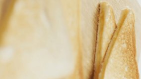 Video of slices of toasted cheese white bread sandwiches on wooden chopping board background. fusion food and fresh homemade snack concept. - Powered by Shutterstock - Get 15% off with code: PIKWIZARD15