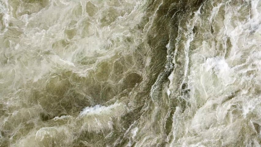 Aerial drone top view of the swirling and rushing water texture of the Nile River, Jinja, Uganda. Rapids water texture