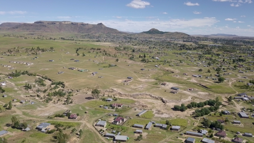Aerial wide. African Village houses and homesteads near Maseru, in the mountain kingdom of Lesotho in Southern Africa. Daytime.