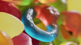 Video of colourful jelly candy on white background. colourful fun food, candy, snacks and sweets concept.