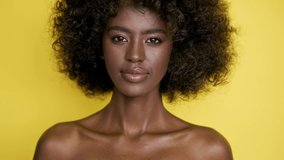 Smiling ethnic woman applying makeup with brush - Powered by Shutterstock - Get 15% off with code: PIKWIZARD15