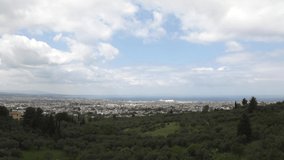A panoramic time lapse clip above a Mediterranean city with beautiful fast motion of the clouds and shadows on the hills and city. Patras, Greece.