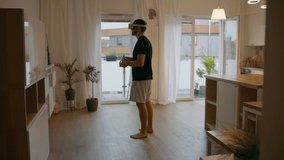 WIDE Caucasian male using his virtual reality headset at home in the kitchen. Preparing for a VR 360 workout