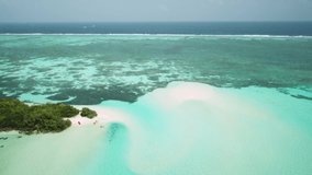 Aerial drone video of an abandoned island with a sandbar or sandy island in Maldives. Beautiful turquoise water all around. Exotic abandoned island in Indian ocean.