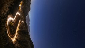 Night time lapse of a road winding through the mountains. - Powered by Shutterstock - Get 15% off with code: PIKWIZARD15