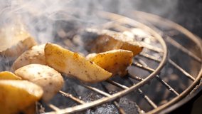 Close up smoked potato on grill. Summer barbecue 4k video. Outdoor cooking 