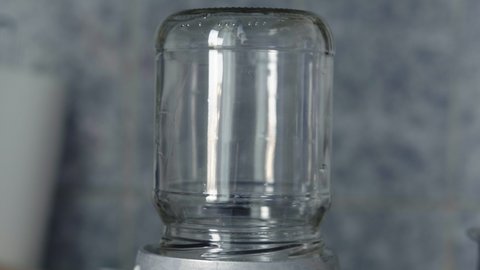 Close-up, glass jar sterilized by steam on a gas stove