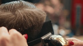 Barbershop: a woman barber cuts client's man's hair