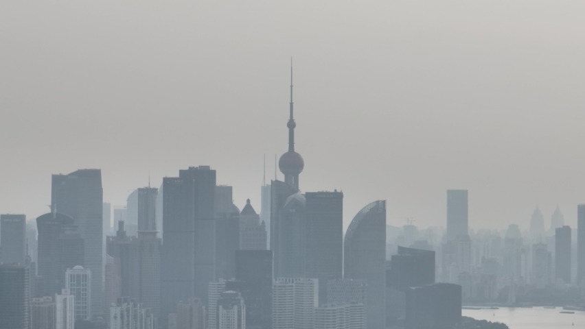 Drone aerial view of City skyline in the heavy fog in cloudy day. Long distance shot of skyline in Lujiazui downtown district in Shanghai China. Business, travel and economy concept b-roll footage.
