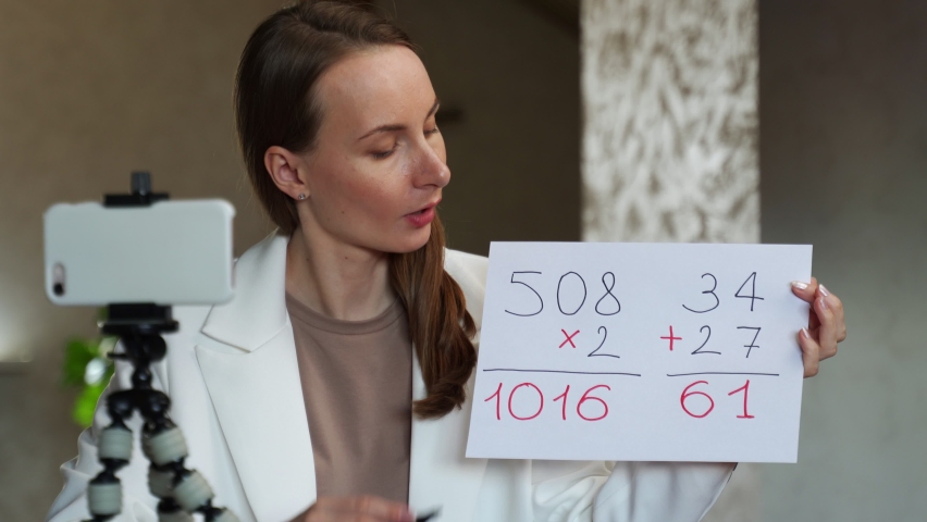 Young teacher teaching video conference e-learning to elementary school student. 