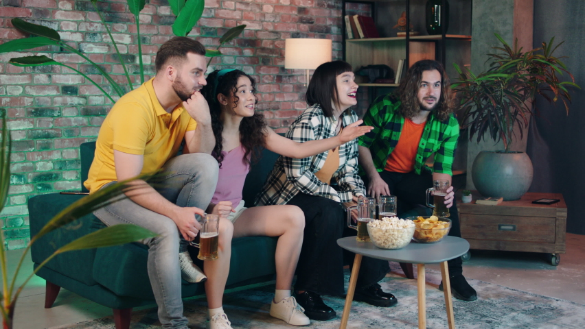 Charismatic and good looking multiethnic friends meeting together in living room watching some sport match they analysing the score and enjoy the time together | Shutterstock HD Video #1091976093