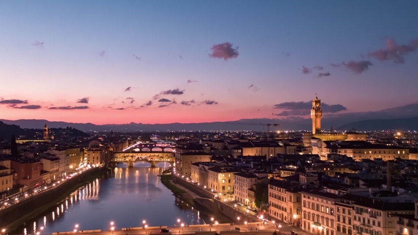 Establishing aerial view of Florence Cathedral, Firenze Cattedrale di Santa Maria del Fiore, Ponte Vecchio and Arno River on a beautiful colourful dusk sky, Tuscany region of Italy Florence Royalty-Free Stock Footage #1091979875