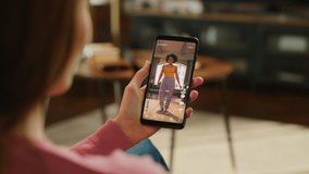 Person Using Social Media App on Smartphone, Looking at Live Stream Videos. Realistic Feed Scrolling on Mock-up Application Posts: Creativity, Dancing, Meme, Lifestyle, Device Review, Viral Content - Powered by Shutterstock - Get 15% off with code: PIKWIZARD15