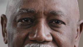 Close-up male dark eyes wrinkled face African American old man looking at camera with sad expression elderly senior man poor vision trouble eyesight problem ophthalmology insurance health care service - Powered by Shutterstock - Get 15% off with code: PIKWIZARD15
