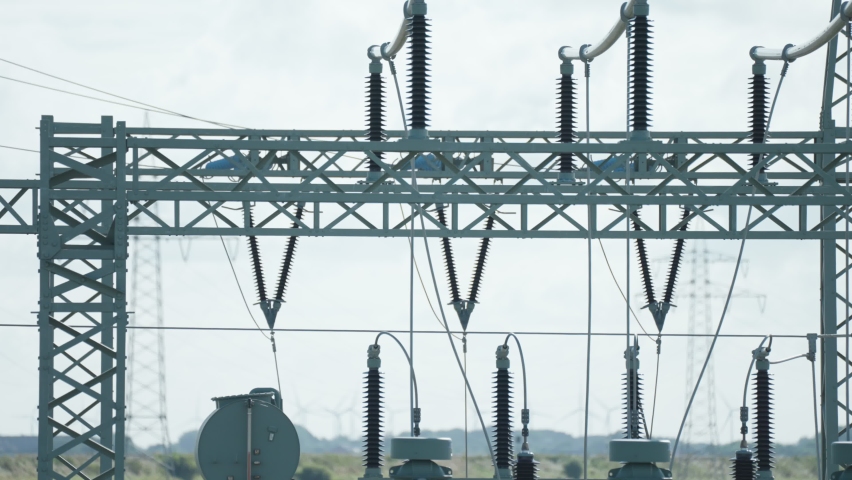 A close-up shot of an electrical power plant. Slow-motion, pan right