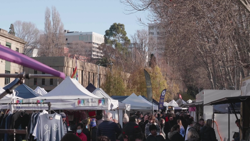 Hobart , Tasmania , Australia - 07 02 2022: Hobart, Tasmania, July 2nd 2022 - Tourist wandering stalls on streets of iconic Salamanca Market in Hobart, Tasmania